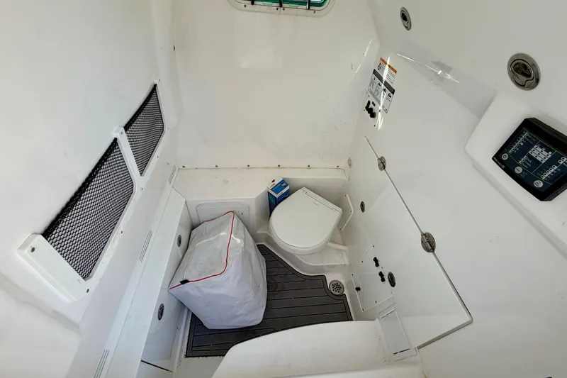 Slide: The Image of 2023 Everglades 285 Center Console interior with toilet and storage area. - 14