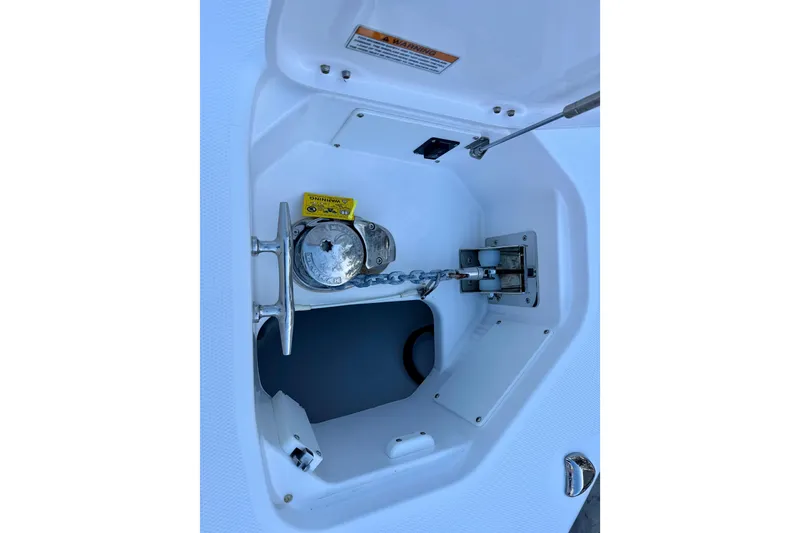 Slide: The Image of Anchor compartment of 2023 Everglades 285 Center Console boat, featuring chain and cleat. - 25