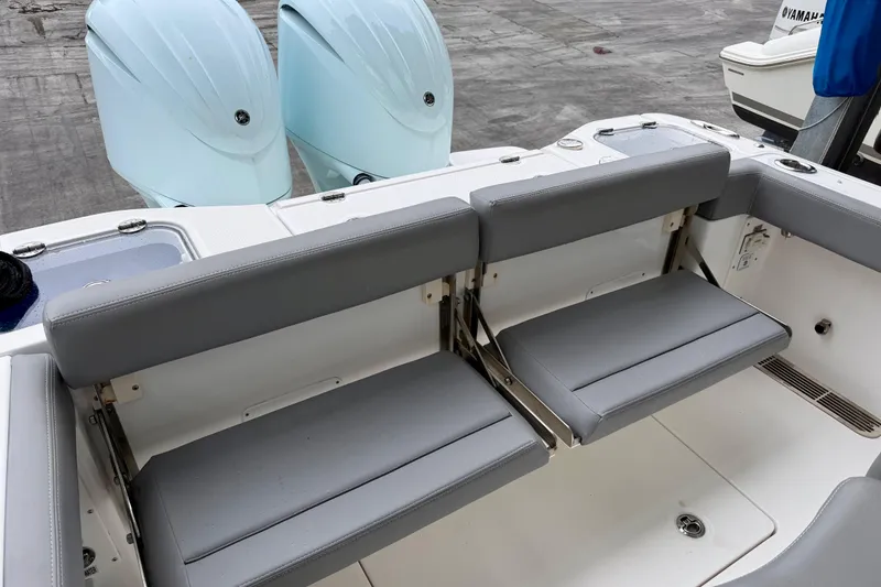 Slide: The Image of 2023 Everglades 285 Center Console boat interior with cushioned seating and speakers. - 3