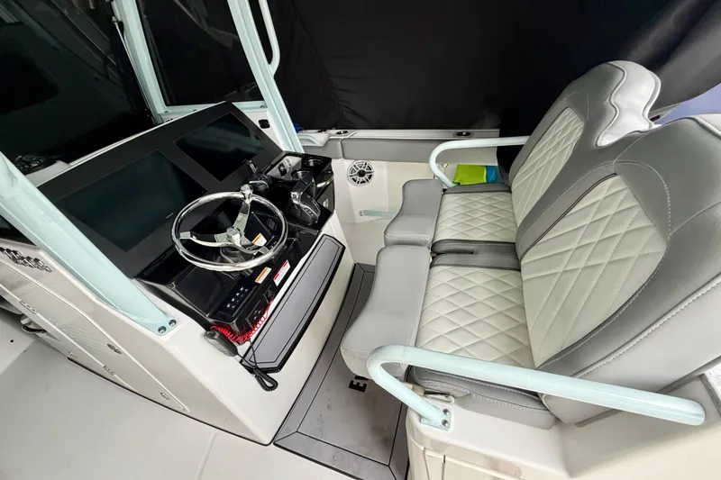 Slide: The Image of 2023 Everglades 285 Center Console boat lifted on a dock under cloudy skies. - 5