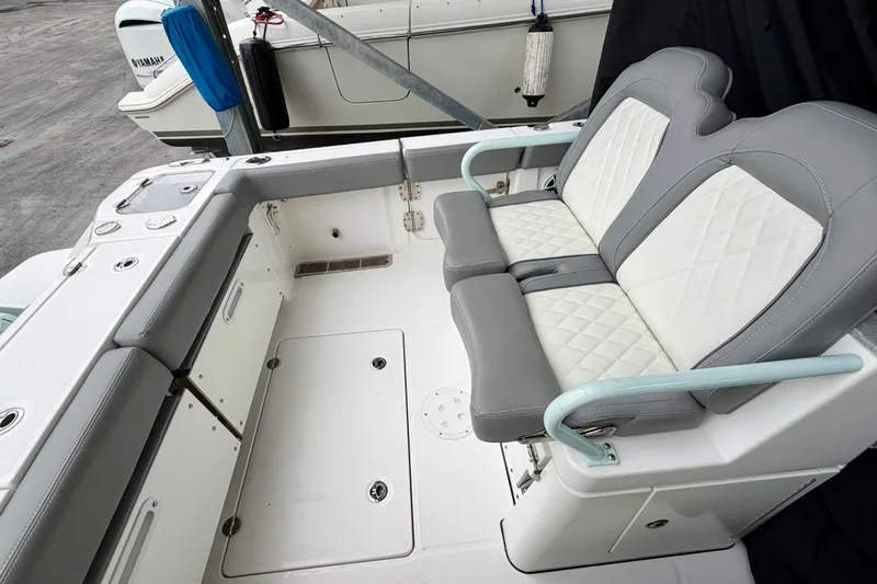 Slide: The Image of 2023 Everglades 285 Center Console boat with dual outboard engines and foldable seating. - 6