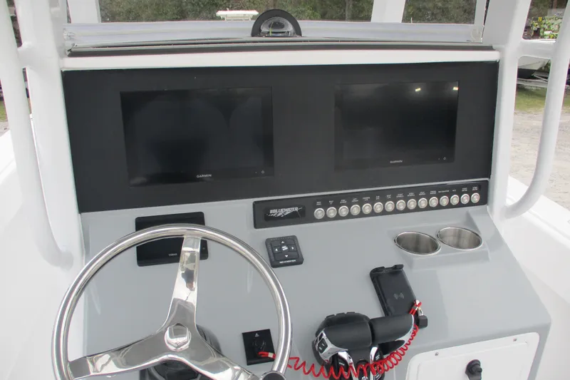 Slide: The Image of 2026 Bluewater 25t boat dashboard with dual Garmin screens and steering wheel. - 11