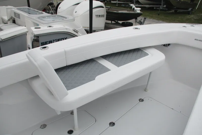 Slide: The Image of 2026 Bluewater 25t boat interior with white seating and storage compartments. - 14