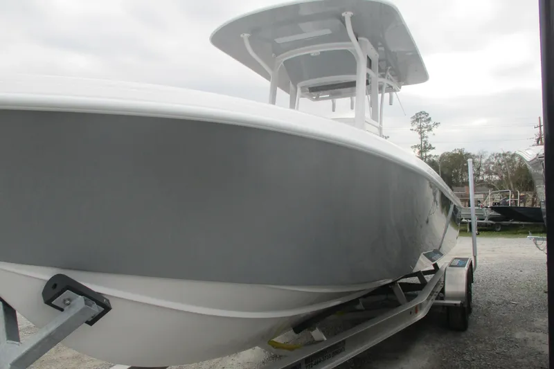 Slide: The Image of 2026 Bluewater 25t boat on trailer, side view, overcast sky. - 3