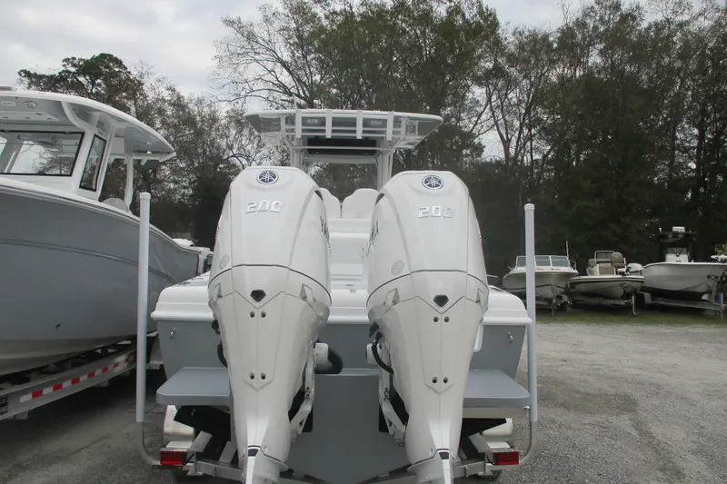 Slide: The Image of 2026 Bluewater 25t boat with dual 200 horsepower engines, parked outdoors. - 4