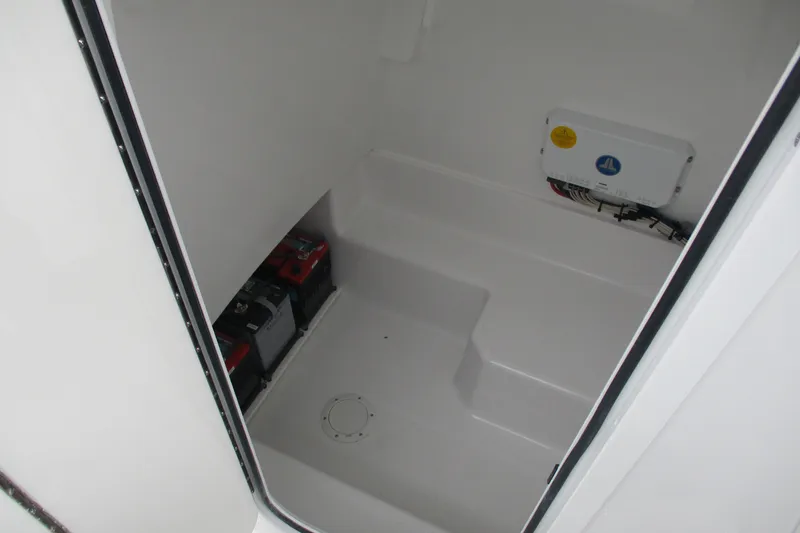 Slide: The Image of Interior view of 2026 Bluewater 25t boat compartment with batteries and wiring. - 9