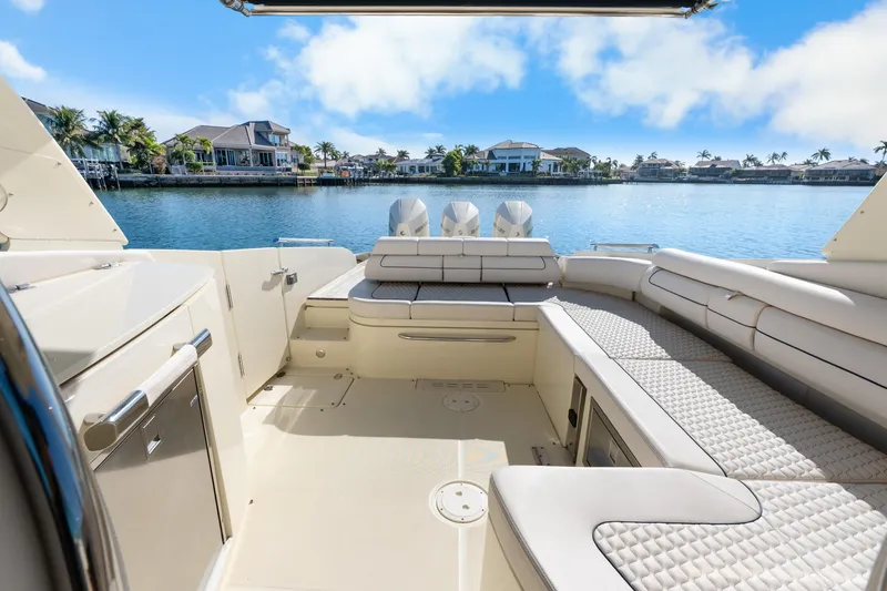 Slide: The Image of 2021 Chris-Craft Launch 35 GT OB boat interior with luxurious seating, overlooking waterfront homes. - 28