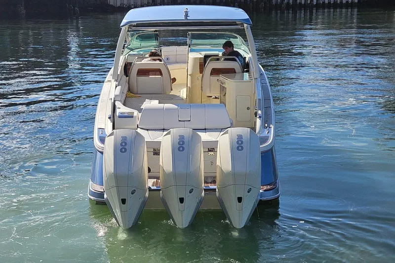 Slide: The Image of 2021 Chris-Craft Launch 35 GT OB boat with triple outboard engines on water. - 3