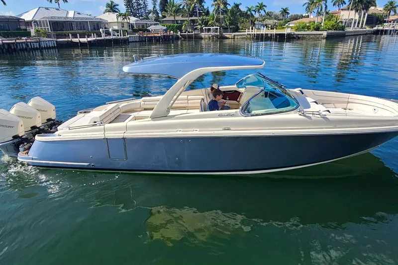 Slide: The Image of 2021 Chris-Craft Launch 35 GT OB boat with dual Mercury outboards on clear water. - 6