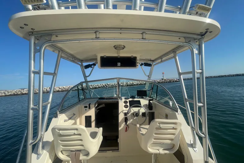 Slide: The Image of 2006 Parker 2310 boat interior with helm, seats, and ocean view. - 10