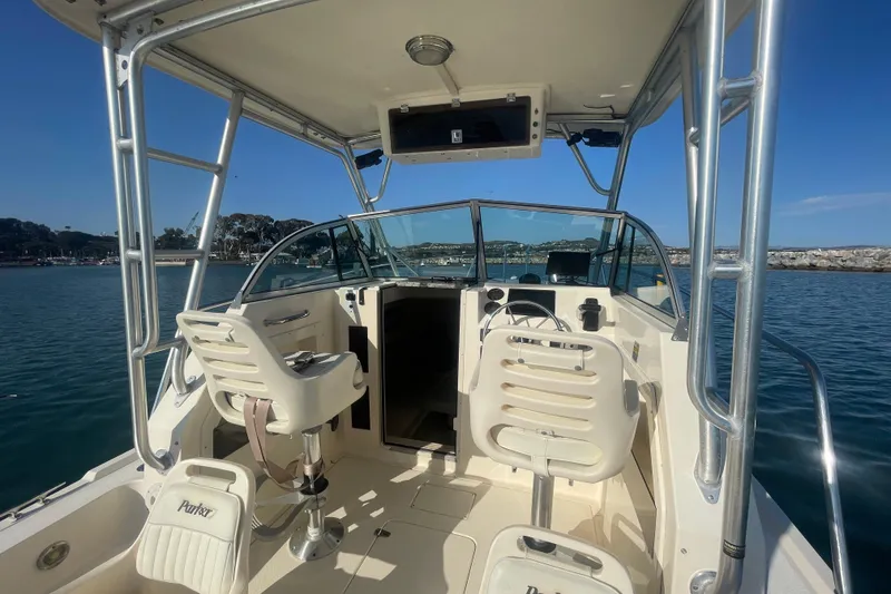 Slide: The Image of 2006 Parker 2310 boat interior with helm, seats, and ocean view. - 11