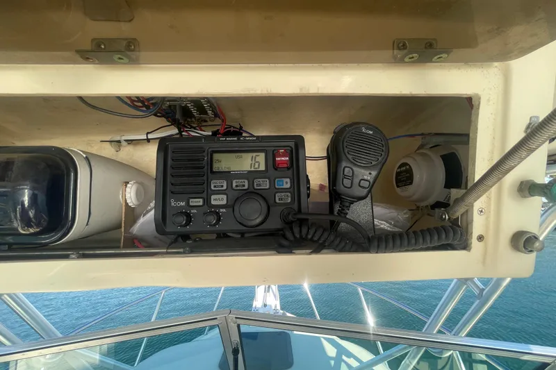 Slide: The Image of Boat dashboard with Icom VHF marine radio, microphone, and equipment on a Parker 2310, 2006 model. - 14