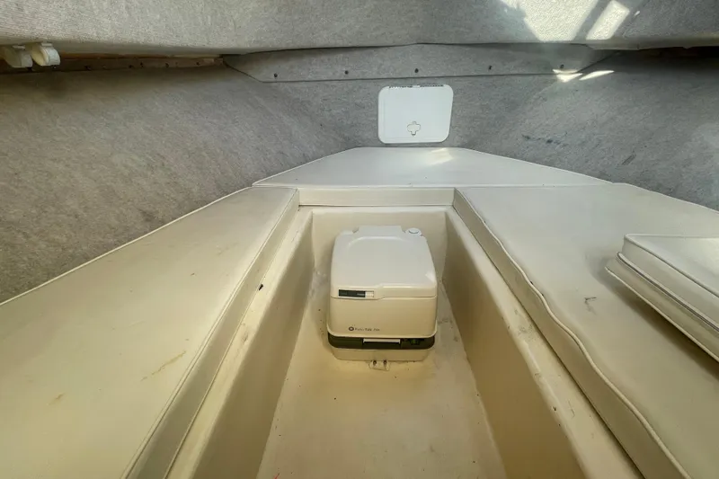 Slide: The Image of 2006 Parker 2310 boat interior with portable toilet in cabin. - 16