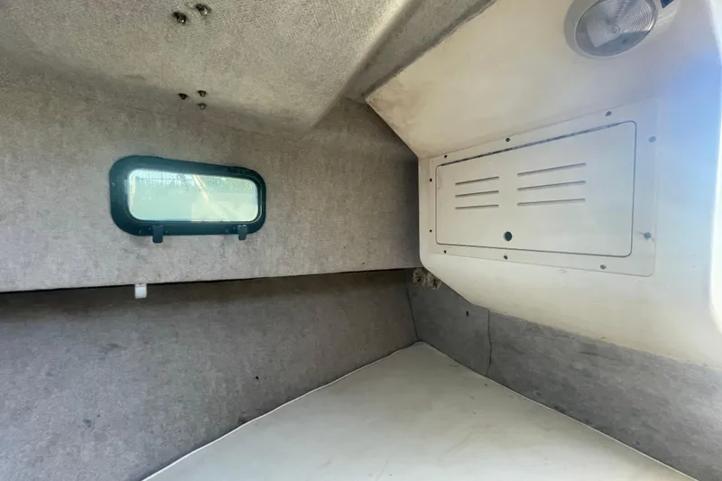 Slide: The Image of Interior cabin of a 2006 Parker 2310 boat with window and storage compartment. - 18