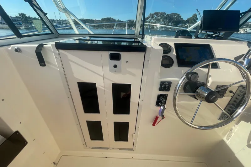 Slide: The Image of Interior view of a 2006 Parker 2310 boat cockpit with steering wheel and controls. - 4