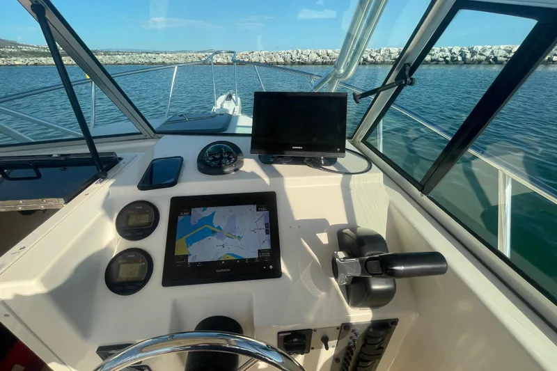 Slide: The Image of Boat dashboard with navigation equipment, Parker 2310, 2006 model, on calm water. - 6