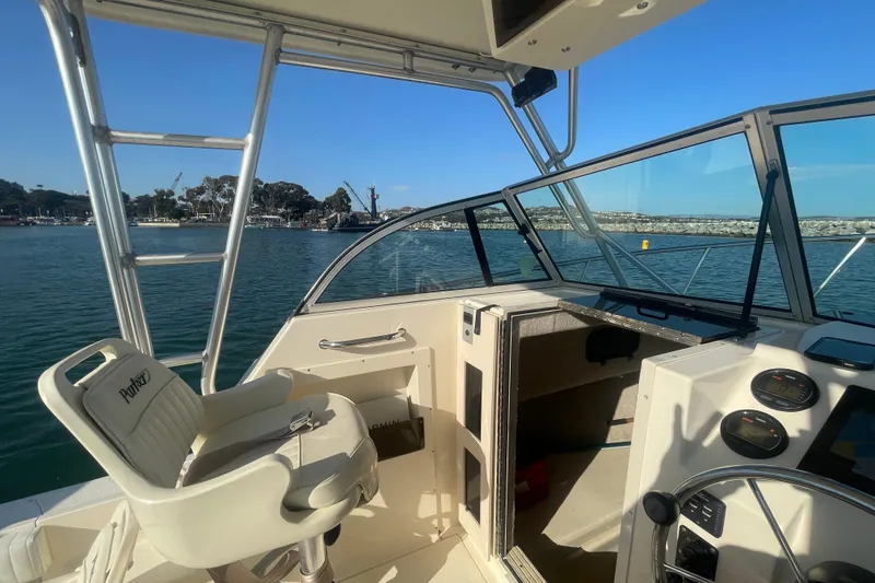 Slide: The Image of Interior view of a 2006 Parker 2310 boat with steering wheel and seating. - 9