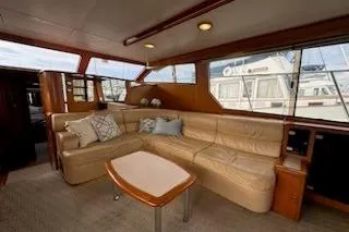 Slide: The Image of Luxurious interior of 1999 Mikelson 50 Sportfisher yacht with leather seating and large windows. - 15