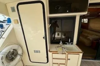 Slide: The Image of 1999 Mikelson 50 Sportfisher interior with sink, storage, and life preserver. - 17
