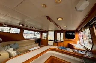 Slide: The Image of Interior of 1999 Mikelson 50 Sportfisher yacht with cozy seating and modern amenities. - 19