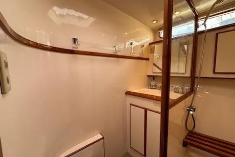 Slide: The Image of 1999 Mikelson 50 Sportfisher yacht bathroom with wood accents and modern fixtures. - 25