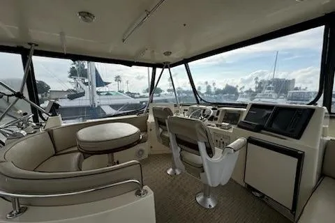 Slide: The Image of Interior of 1999 Mikelson 50 Sportfisher yacht with helm and seating area. - 26