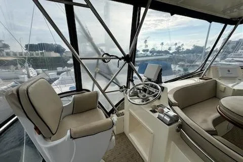 Slide: The Image of Interior of 1999 Mikelson 50 Sportfisher yacht with helm and seating area. - 27