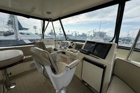 Slide: The Image of Interior of 1999 Mikelson 50 Sportfisher yacht with helm and seating area. - 29
