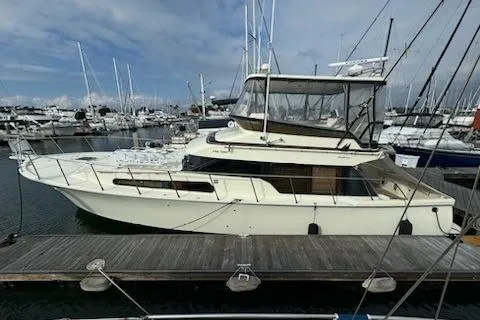 Slide: The Image of 1999 Mikelson 50 Sportfisher yacht docked at marina, surrounded by sailboats. - 7