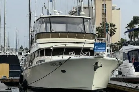 Slide: The Image of 1999 Mikelson 50 Sportfisher yacht docked at marina with surrounding boats. - 8