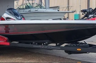 Slide: The Image of 2026 Vexus VXs20 boat on trailer, sleek design, parked outdoors. - 5