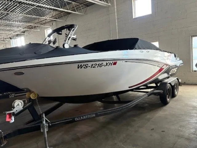 The Image of 2019 Glastron 225 GTS boat on trailer in warehouse. - 0