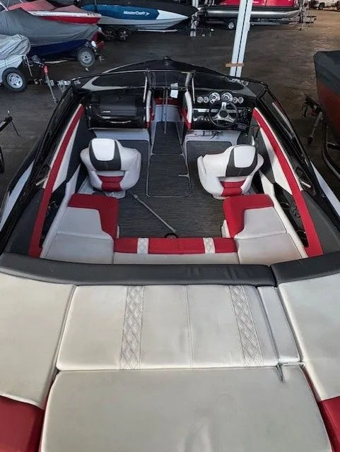 Slide: The Image of Interior view of a 2019 Glastron 225 GTS boat with red and white seating. - 2