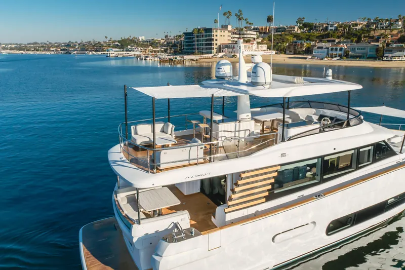 Slide: The Image of Luxury Azimut Magellano 66 yacht, 2023 model, docked in scenic marina setting. - 6