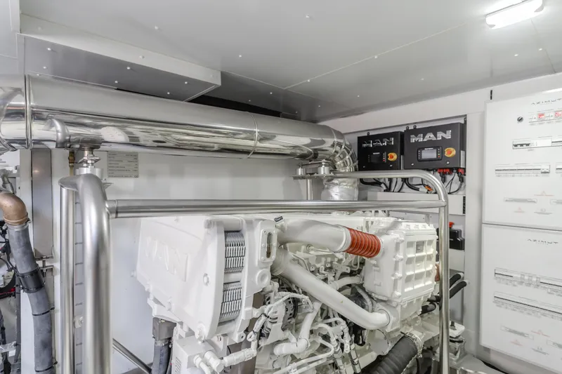 Slide: The Image of Engine room of 2023 Azimut Magellano 66 yacht, featuring MAN machinery and control panels. - 9