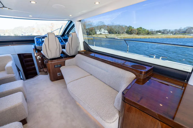 Slide: The Image of Luxurious interior of 2026 Fairline 58 GTO yacht with plush seating and scenic water view. - 10