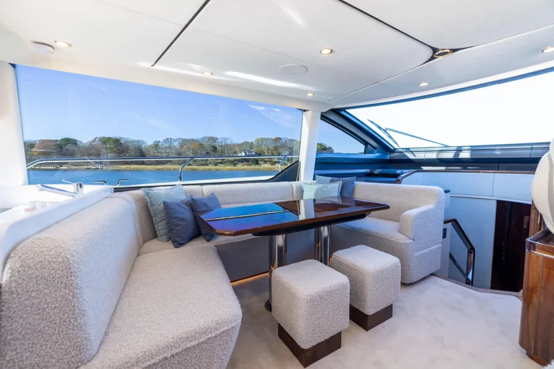 Slide: The Image of Luxurious interior of 2026 Fairline 58 GTO yacht with elegant seating and scenic views. - 11