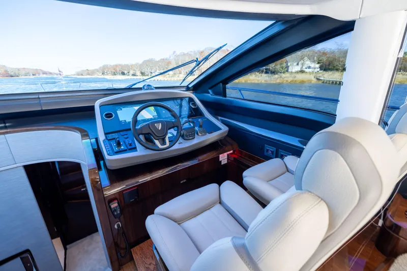 Slide: The Image of Luxurious helm of 2026 Fairline 58 GTO yacht with modern controls and plush seating. - 12