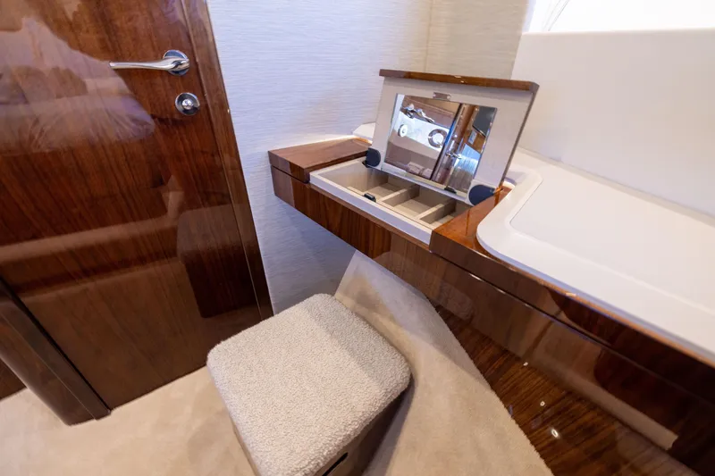 Slide: The Image of Luxurious vanity area in 2026 Fairline 58 GTO yacht with wood finish and mirror. - 17