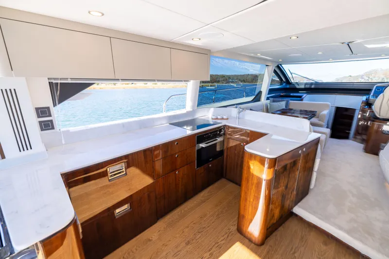 Slide: The Image of Luxurious interior of 2026 Fairline 58 GTO yacht with modern kitchen and seating area. - 7