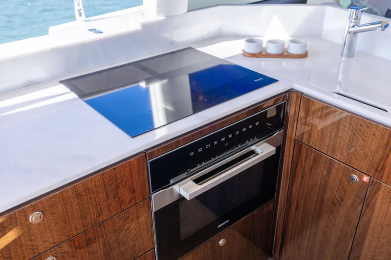 Slide: The Image of Modern kitchen in 2026 Fairline 58 GTO yacht with sleek appliances and wood cabinetry. - 8