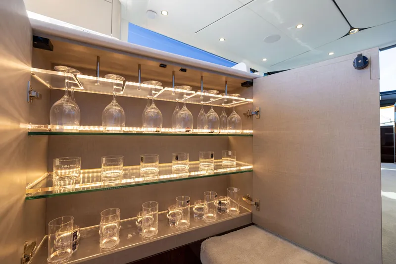 Slide: The Image of Luxury glassware cabinet on 2026 Fairline 58 GTO yacht, featuring elegant lighting. - 9