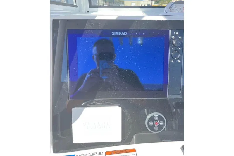 Slide: The Image of Simrad display on 2026 NauticStar 251 Hybrid boat dashboard. - 11