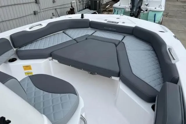 Slide: The Image of 2026 NauticStar 191 Hybrid boat with spacious gray seating and modern design. - 5