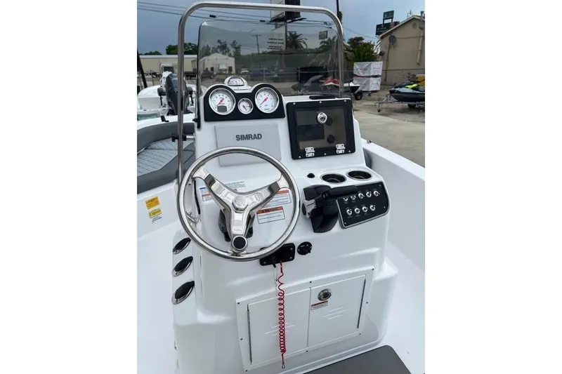 Slide: The Image of 2026 NauticStar 191 Hybrid boat console with steering wheel, gauges, and Simrad display. - 6