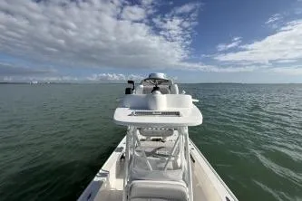 Slide: The Image of 2024 SeaVee 270Z boat on open water under a partly cloudy sky. - 3