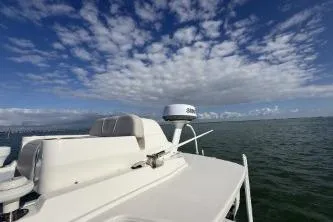 Slide: The Image of 2024 SeaVee 270Z boat on open water under a partly cloudy sky. - 4