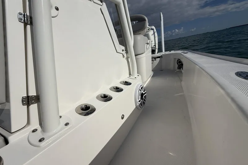 Slide: The Image of 2024 SeaVee 270Z boat interior with rod holders and speaker, ocean view. - 5