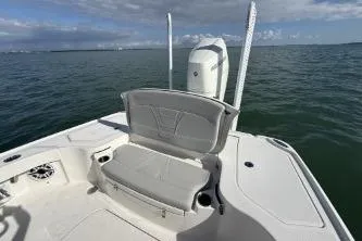 Slide: The Image of 2024 SeaVee 270Z boat with seating, on calm ocean waters under a partly cloudy sky. - 6