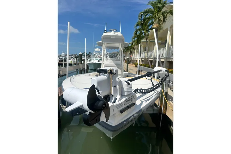 Slide: The Image of 2024 SeaVee 270Z boat docked, featuring a Minn Kota trolling motor. - 7